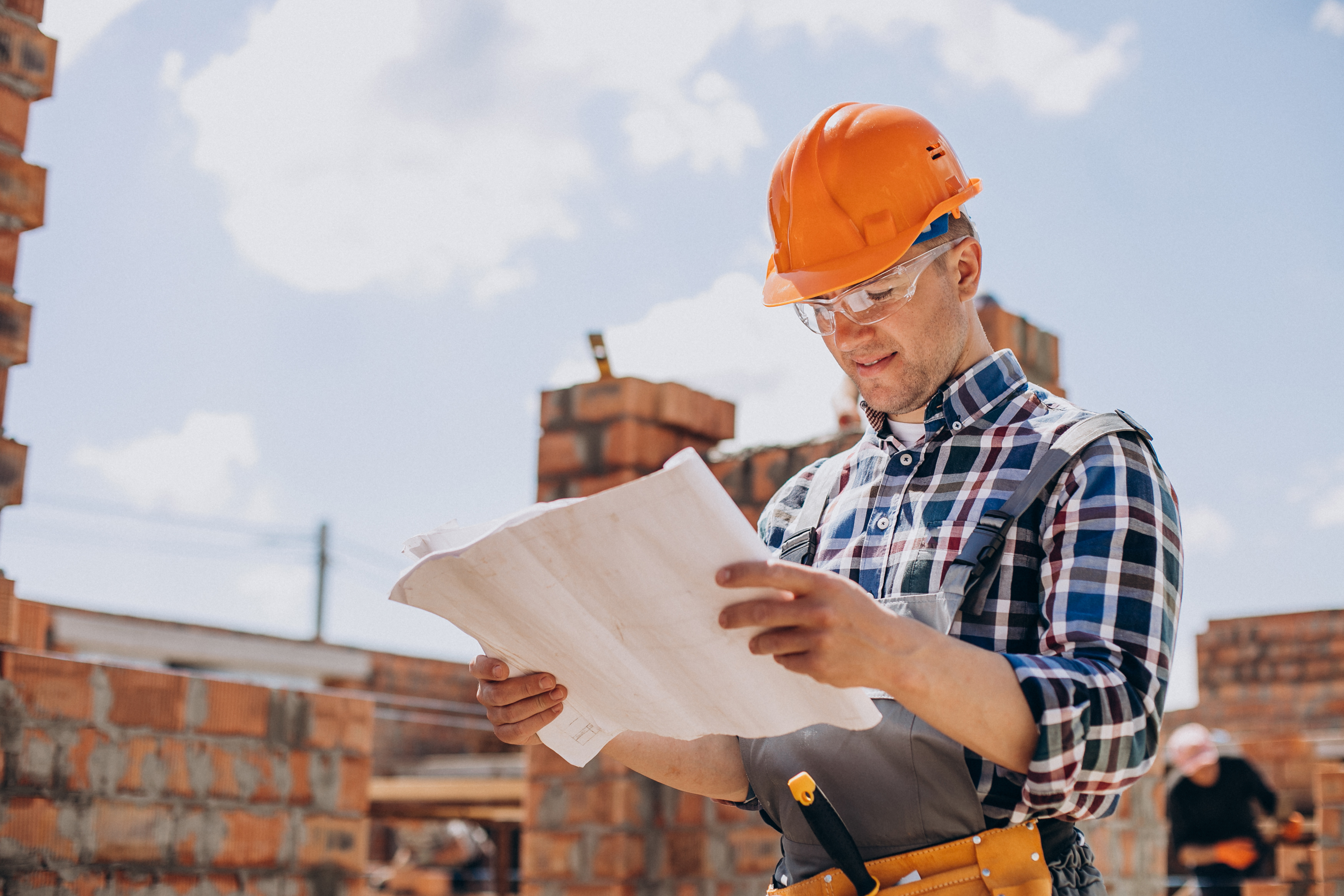 Young craftsman building a house